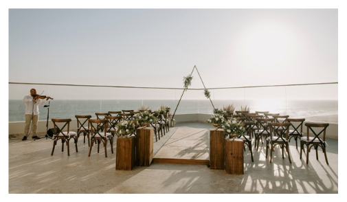 Couple walking along a palm-lined beach